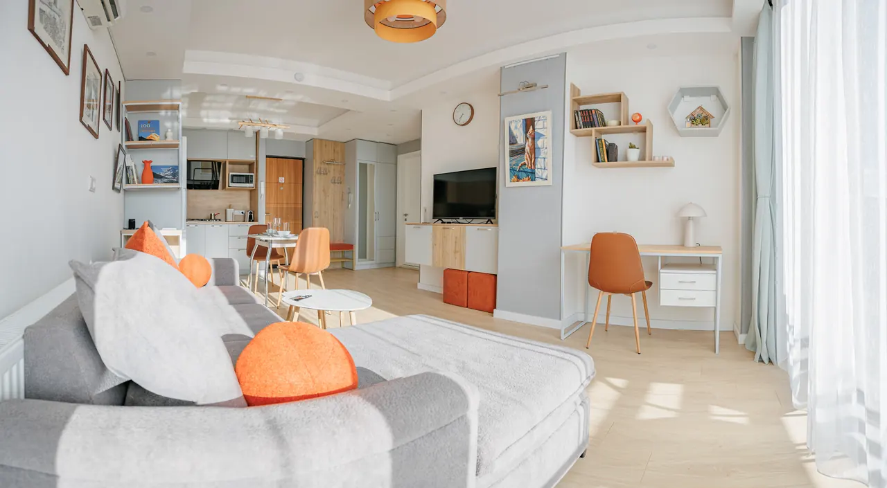 Orange Cat living room with kitchen, workspace, panoramic windows and original artwork