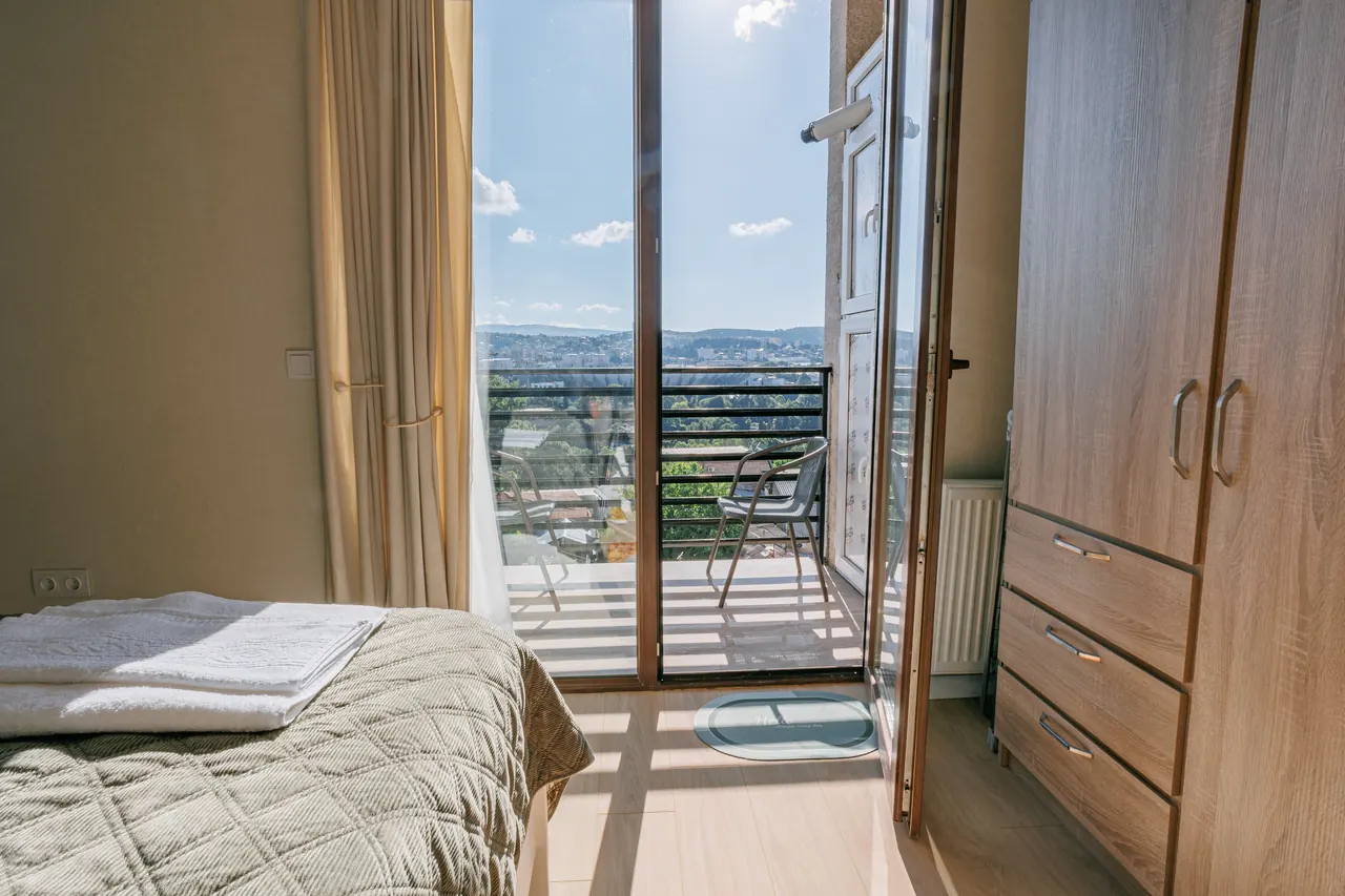 City panorama visible from the bedroom
