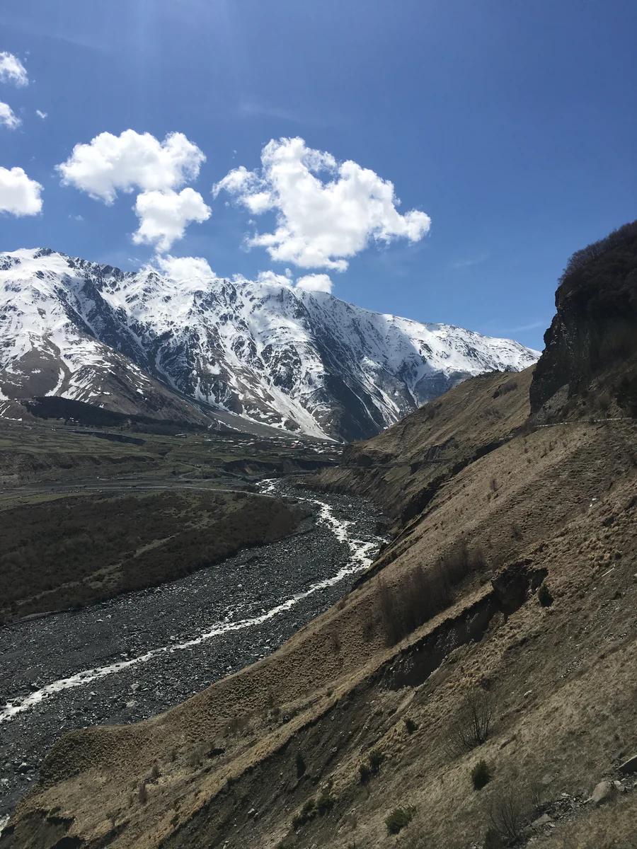 River below snow-covered mountains on the Upper Lars route
