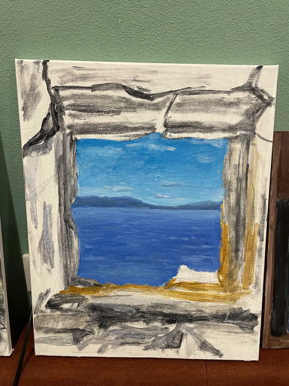 Painting in progress showing a framed sea view