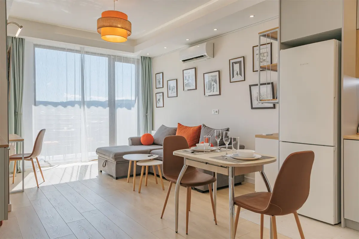 Kitchen-living room with sofa, dining area and panoramic windows